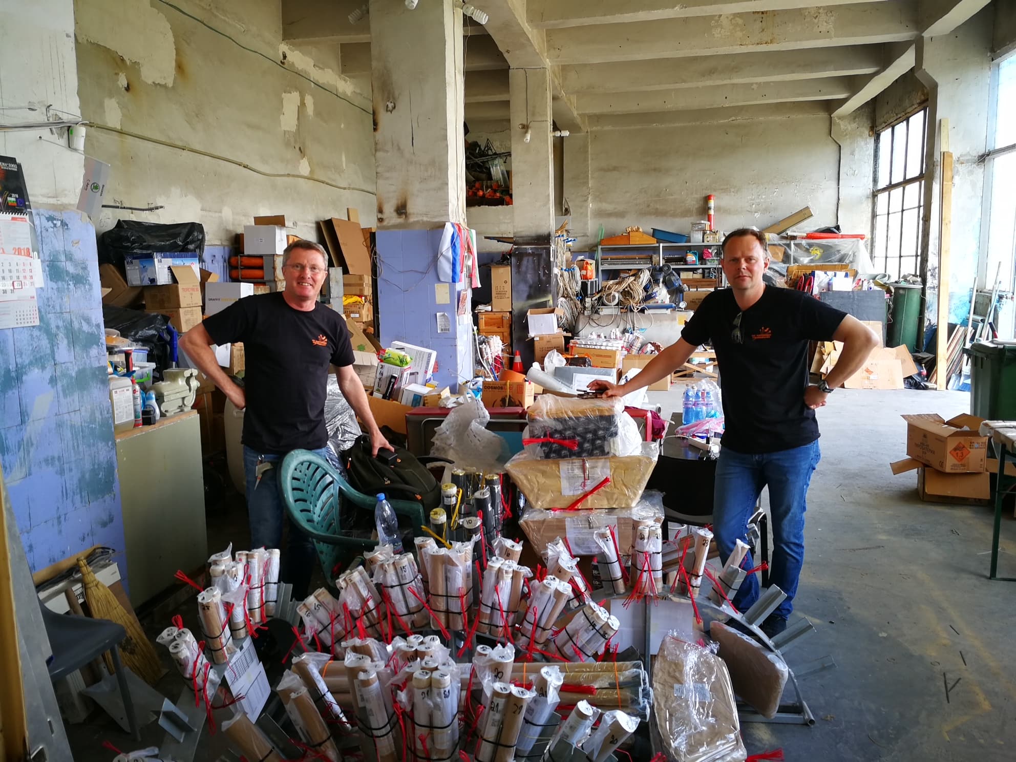 Two people amongst fireworks at a storage facility